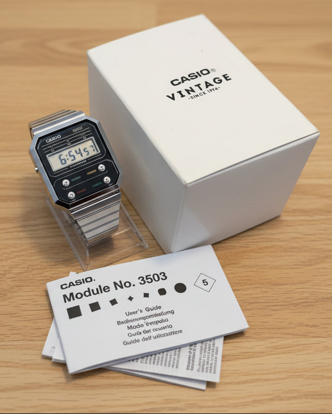 Casio watch with packaging and manual on a light gray background