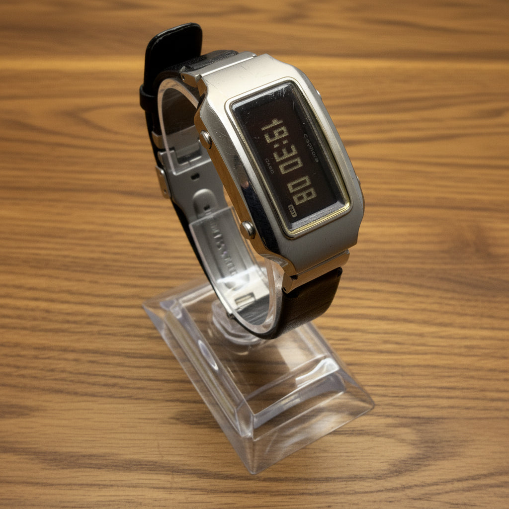 Digital watch with a clear plastic cover on a light gray background