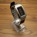 Digital watch with a clear plastic cover on a light gray background