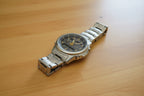 Silver Casio watch on a dark background with a Casio logo.