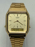 Gold Casio watch on a light gray background