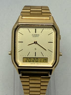 Gold Casio watch on a light gray background