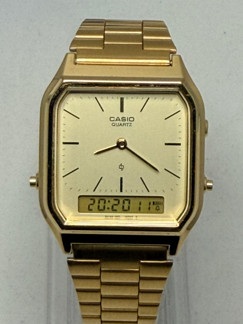 Gold Casio watch on a light gray background