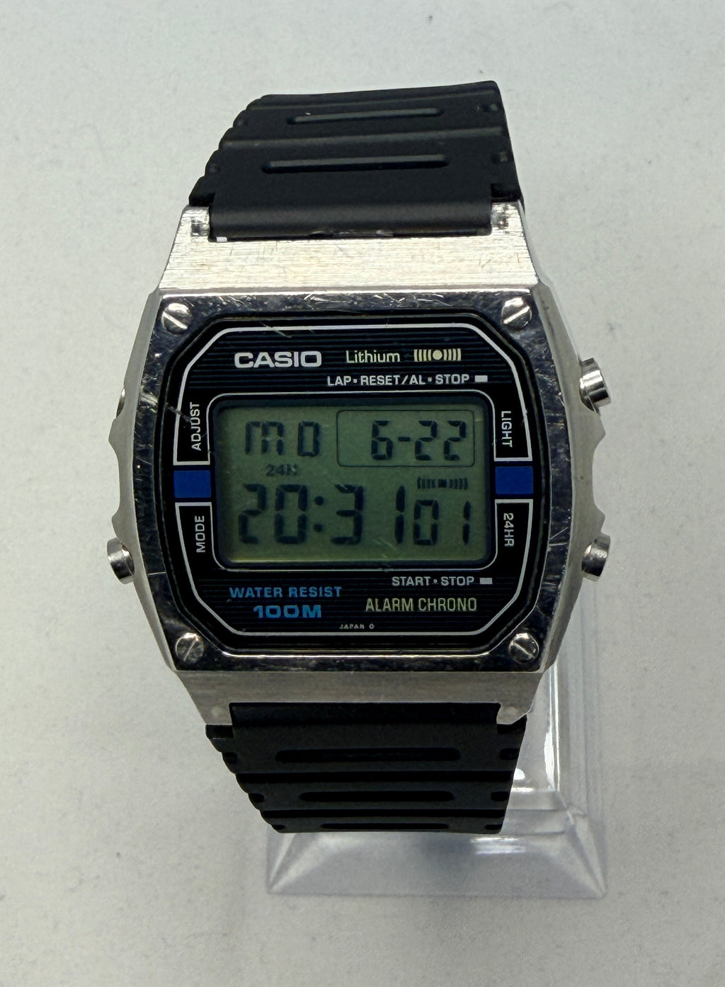 Digital watch with black strap on a white background, Casio branding visible.