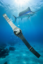Digital watch with a metal strap on a light gray background
