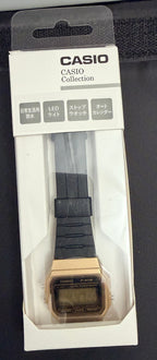 Casio Collection digital watch in its original white and black retail packaging, featuring a gold-tone case and a black strap.