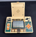 A vintage Casio handheld gaming console with a cream-colored plastic body, teal green faceplates, and orange buttons, shown with its lid open displaying the screen.